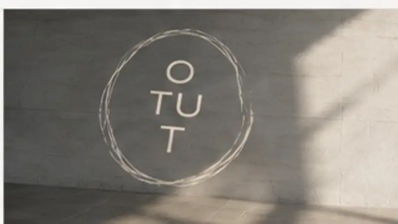 OTUT hand-drawn circle identity in a sunlit space